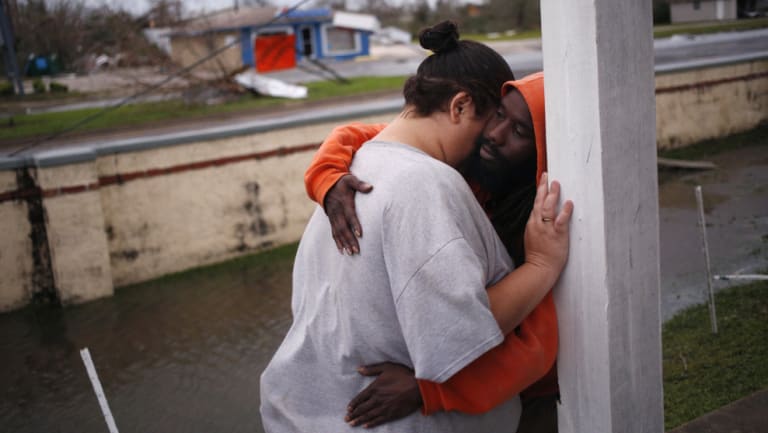 Residents embrace in front of an apartment building after Hurricane Michael hit in Panama City in Florida on Wednesday.