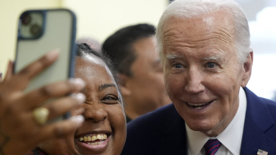 US President Joe Biden poses for a photo as he visits CJ’s Cafe in Los Angeles.
