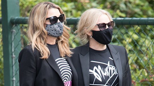 Sisters Kylie and Dannii Minogue at the funeral for Mushroom Group founder Michael Gudinski on Wednesday. 