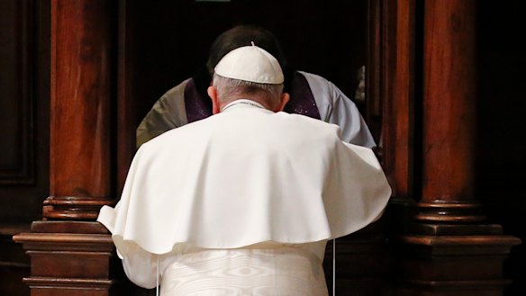 Pope Francis kneels in confession during a penitential liturgy in St. Peter's Basilica at the Vatican.