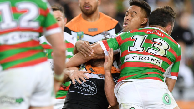 All is forgiven: Burgess collects Tigers hooker Robbie Farah across the face.