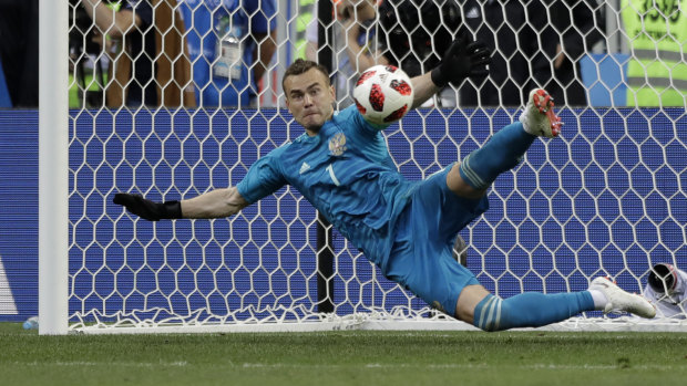 Clutch: Igor Akinfeev makes a save during the penalty shootout.