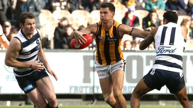 Cutting a swathe: Hawk Jaeger O'Meara breaks past Tim Kelly (right) and Patrick Dangerfield of the Cats.