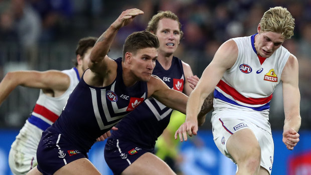 Evasive action: Bulldog Tim English moves the ball on before a tackle from Docker Rory Lobb.