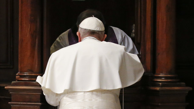 Pope Francis kneels in confession during a penitential liturgy in St. Peter's Basilica at the Vatican.