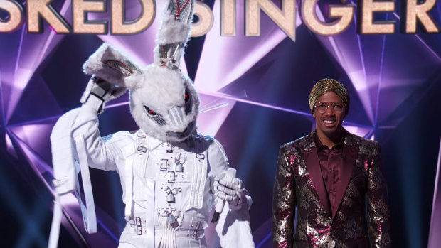 A mystery celebrity in a rabbit costume, alongside host Nick Cannon.