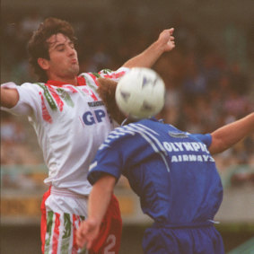 Olympic's Glen Johnson (obscured) tries to control the ball in front of a Morwell Falcons opponent in 1995.