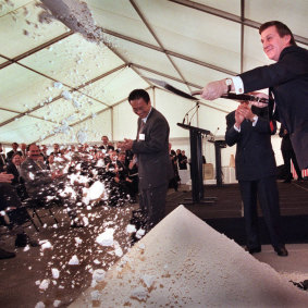Then-premier Jeff Kennett shovels sand at the media as he launches construction on CityLink in 1996.