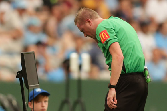 Referee Kurt Ams checks the VAR monitor before deciding to give Rhyan Grant a red card on Sunday.