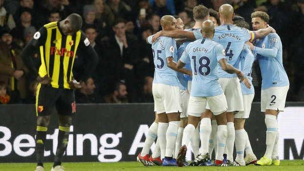 Bundle of joy: Leroy Sane is covered by his teammates after scoring for Manchester City.