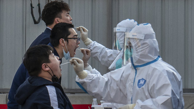 Health workers test residents in Beijing.