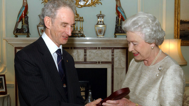 Queen Elizabeth II awards Lord May of Oxford the Insignia of a Member of the Order of Merit, 2002. 
