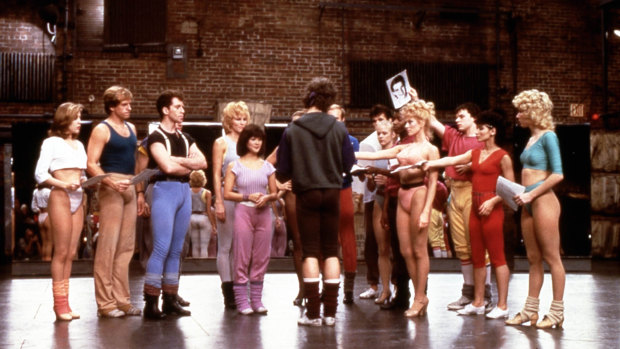 A scene from the 1985 film A Chorus Line, as the dancers hand over their headshots after being picked to go through to the next round of auditions.