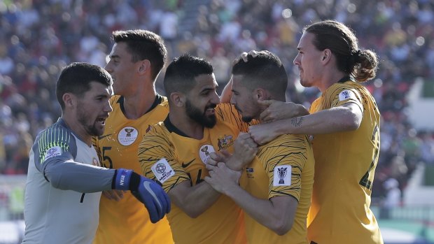 Off the mark: The Socceroos celebrate Jamie Maclaren's opening goal against Palestine.