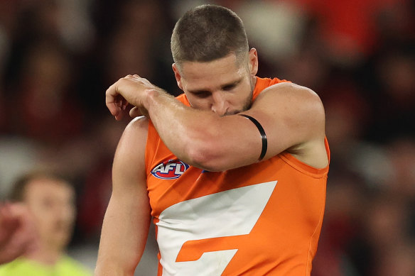 GWS star Jesse Hogan kisses his armband.