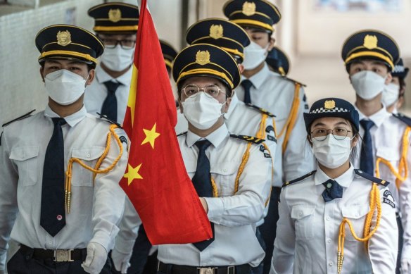 Students march with a Chinese national flag during a flag-raising ceremony to mark the 25th anniversary of Hong Kong’s return to Chinese rule at Scientia Secondary School in Hong Kong on Thursday.