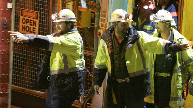 May 9, 2006: Miners Todd Russell, left, and Brant Webb, centre, take their first steps above ground after two weeks trapped nearly a kilometer underground  in the Beaconsfield Gold Mine.