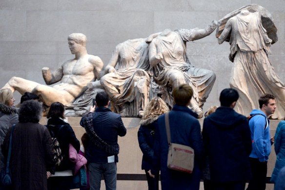 Visitors look at The Parthenon Marbles, also known as the Elgin Marbles in the British Museum.