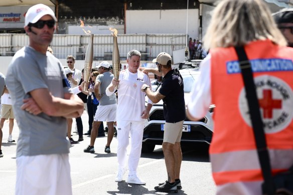 Nine CEO Mike Sneesby carries the Olympic torch.