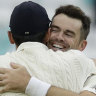 Top of the world: Jimmy Anderson celebrates his record-breaking wicket with friend and teammate Alastair Cook.