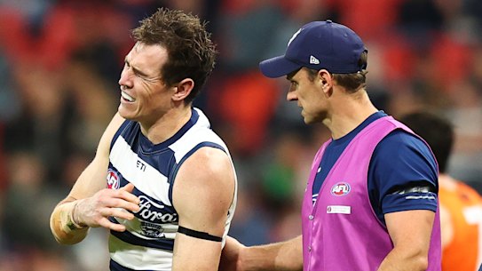 Jeremy Cameron of the Cats leaves the field with an injury.