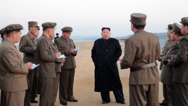 Kim Jong-un, centre, listens to a military official as he inspects a weapon testing at the Academy of National Defence Science, North Korea.