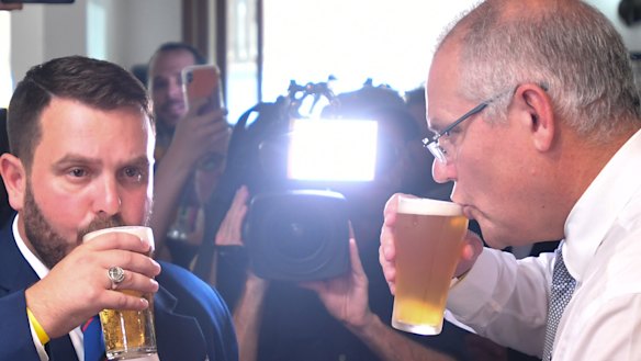 Scott Morrison sips his beer alongside the Liberal candidate for Herbert, Phillip Thompson, on Anzac Day.