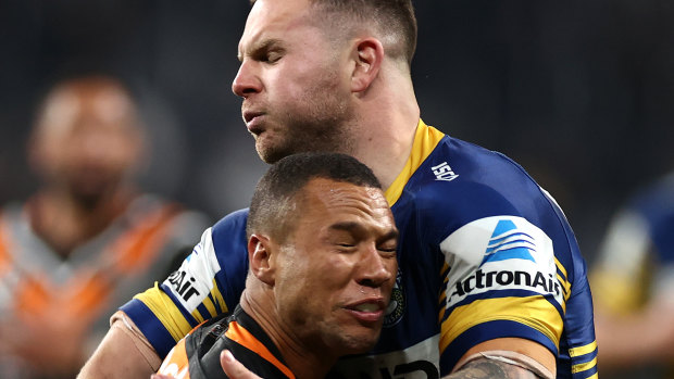 Moses Mbye is tackled by Nathan Brown.