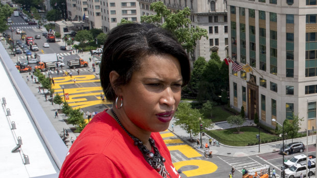 District of Columbia mayor Muriel Bowser stands on the rooftop of the Hay Adams Hotel near the White House and looks out at the words 'Black Lives Matter' that have been painted in bright yellow letters on the street.
