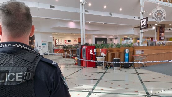 Police had tape near the upstairs food court to prevent the public from looking down to the crime scene on the ground floor.