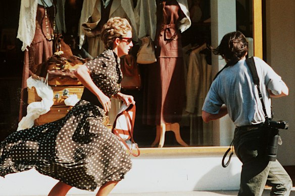 Diana runs from a pursuing photographer in 1997.