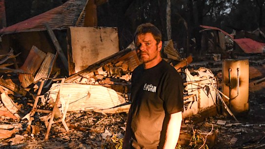 Russell Marriott in front of his burnt out home two days after the fire in Mallacoota.