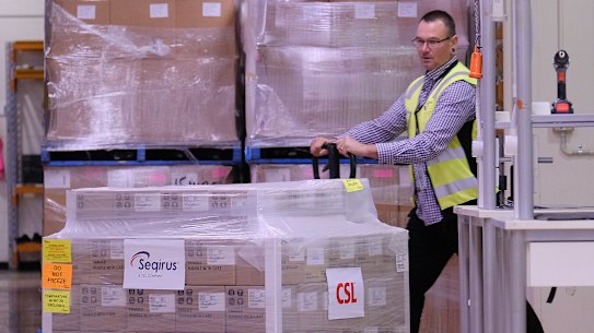 A worker rolls a batch of AstraZeneca vaccines onto a truck at a CSL factory in Melbourne. 