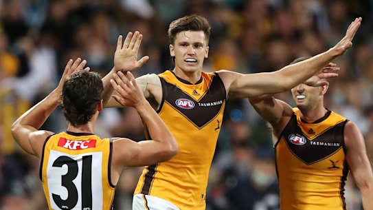 ADELAIDE, AUSTRALIA - MARCH 26: Mitch Lewis of the Hawks celebrates a goal with Connor Macdonald and Luke Breust during the 2022 AFL Round 02 match between the Port Adelaide Power and the Hawthorn Hawks at Adelaide Oval on March 26, 2022 In Adelaide, Australia. (Photo by Sarah Reed/AFL Photos via Getty Images)