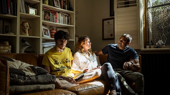 Elisa Hill, Phillipe Yardin and their son Jai, who has severe autism, enjoy the late afternoon sunlight in their home.