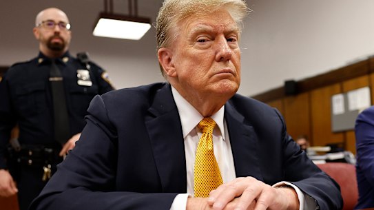 Former president Donald Trump sits in the courtroom for his trial at the Manhattan criminal court during his trial.