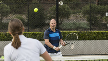 Federal Treasurer Josh Frydenberg with ex-professional tennis player Sally Peers at the Kooyong Tennis Club.