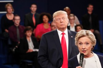 Donald Trump stands behind Hillary Clinton during a 2016 debate.