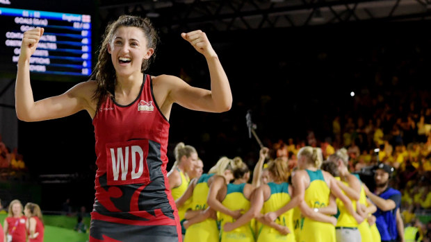 The Australian netballers regroup after defeat as Beth Cobden celebrates for England.