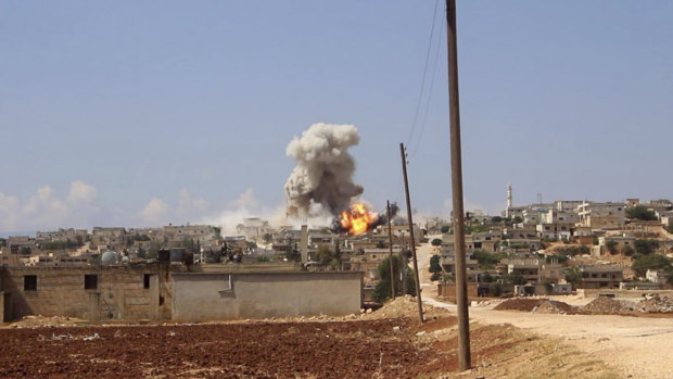 Flames and smoke rising from a Syrian government air strike near Idlib in 2018. 