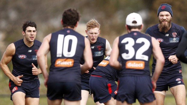 Stepping up: Demons Christian Petracca (left), Clayton Oliver (3rd from left) and Max Gawn (3rd from right)  during training.