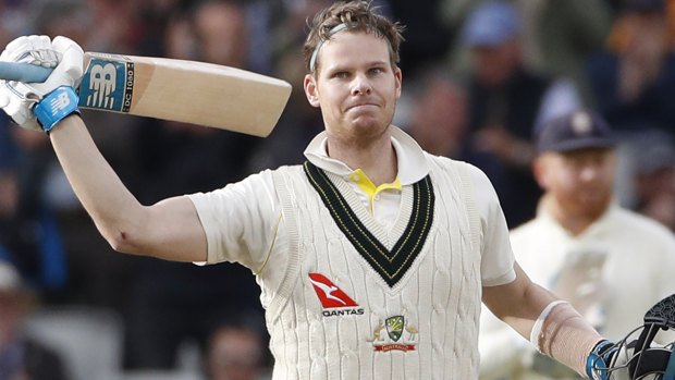 Smith raises his bat after scoring 200 runs.