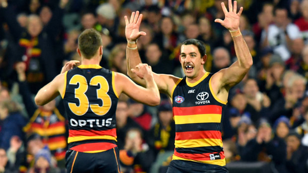 Taylor Walker celebrates a goal with Brodie Smith. 