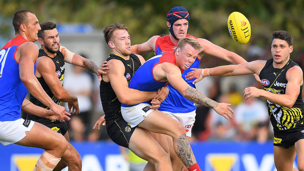 Wrapped up: Richmond's Noah Balta gets to grips with Melbourne's James Harmes in their JLT series match on Sunday.