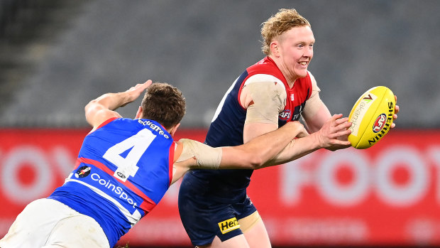 Clayton Oliver is tackled by Marcus Bontempelli.