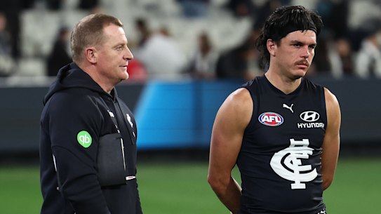 Elijah Hollands (right) with Blues coach Michael Voss after the loss to Collingwood.