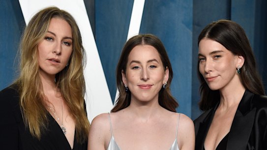 Este Haim, from left, Alana Haim, and Danielle Haim arrive at the Vanity Fair Oscar Party in 2022.