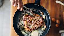 Stock image of a steak being cooked