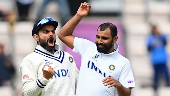 Virat Kohli and Mohammed Shami celebrate the wicket of Colin de Grandhomme.