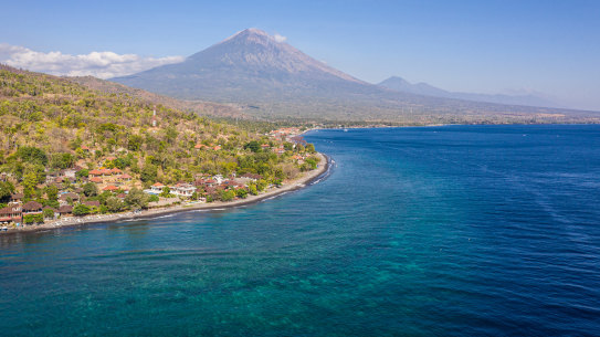 The shadow of Mount Agung looms over Amed.